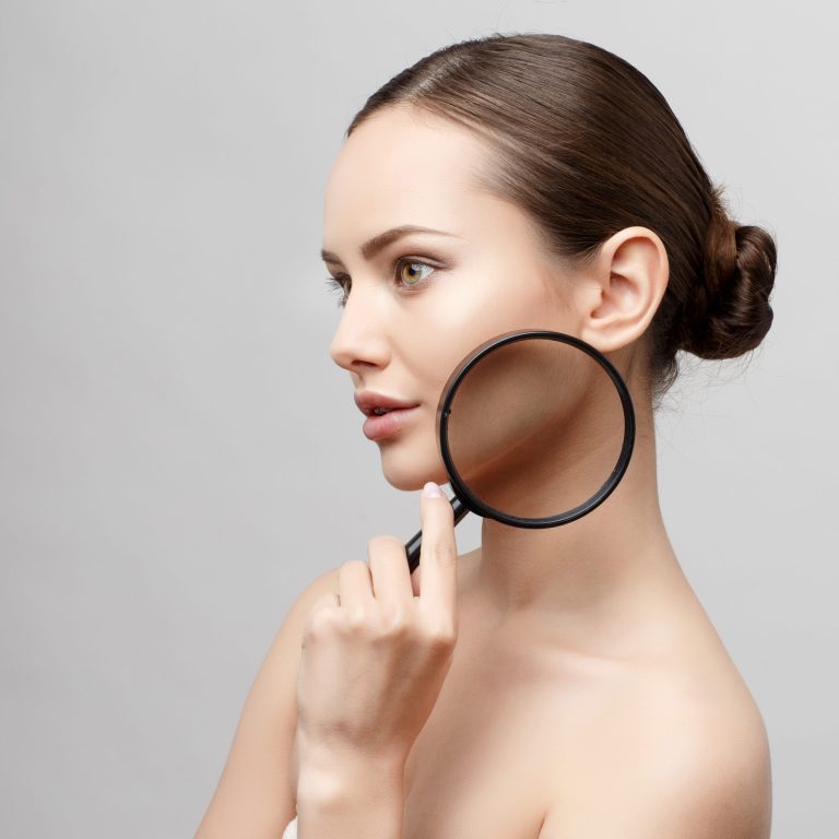 Beautiful Face of Young Woman with Clean Fresh Skin close up isolated on white. Beauty Portrait. Beautiful Spa Woman Smiling. Perfect Fresh Skin. Pure Beauty Model. Youth and Skin Care Concept